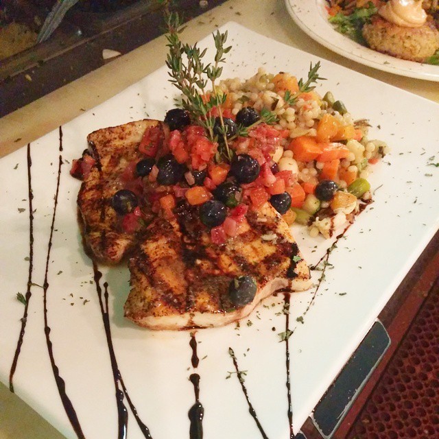 #GrilledSwordfish presented on roasted vegetable couscous & bay scallops topped with a strawberry-blueberry-pineapple salsa and #cilantro. Enjoy - from Instagram